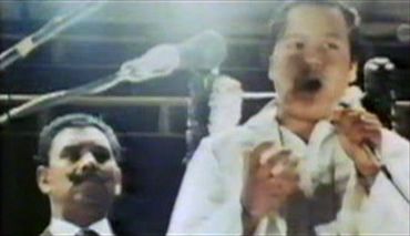 Bihari Singh stands behind Prem Rawat (Maharaji) at Glastonbury 1971